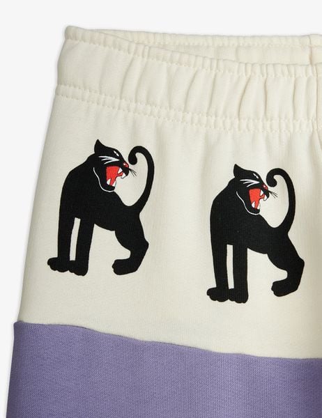 Close-up of the cream-coloured front panel featuring black Panther prints and an elasticated waistband.