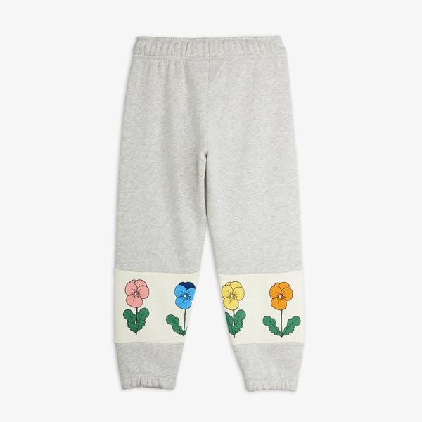 Grey melange sweatpants with colorful Violas print on cream leg panels, shown from the back.