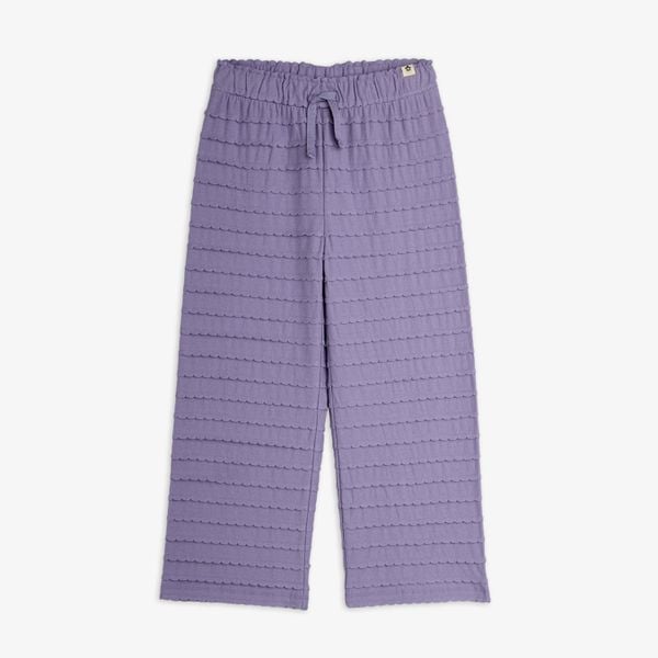 Purple trousers featuring textured horizontal frills, scalloped edges, and an elastic drawstring waist.