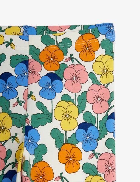 Close-up of leggings featuring a colorful all-over floral print with blue, orange, yellow, and pink pansies.