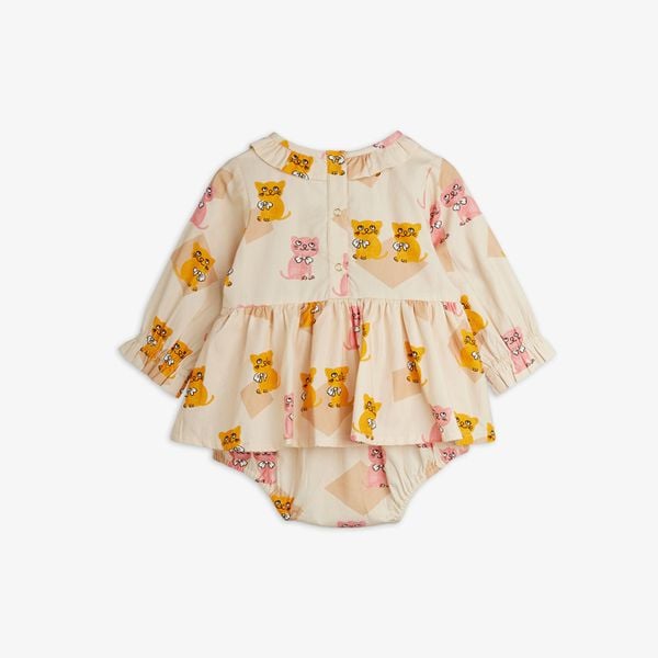 Beige bodysuit featuring a Kittens print, ruffled collar, skirted waist, long sleeves, and back snap buttons, shown from the back.
