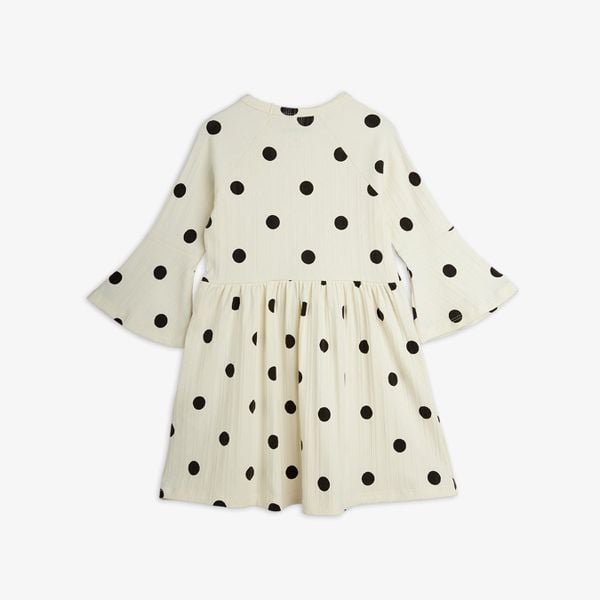 Off-white dress featuring a black Dots pattern, flared trumpet sleeves, and shown from the back.