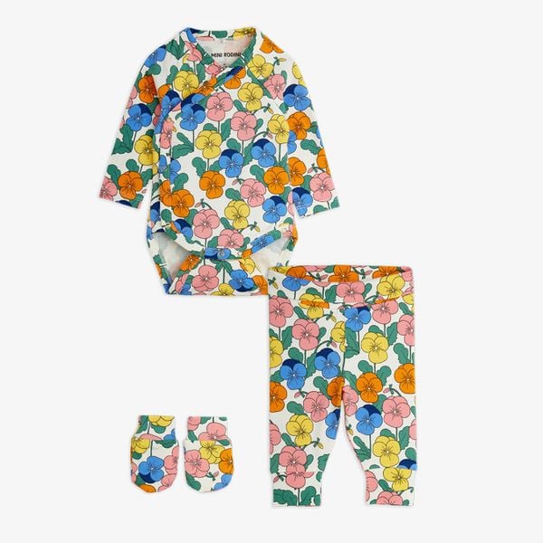 Three-piece newborn kit in a colorful Violas print, including a wrap bodysuit, trousers, and mittens.