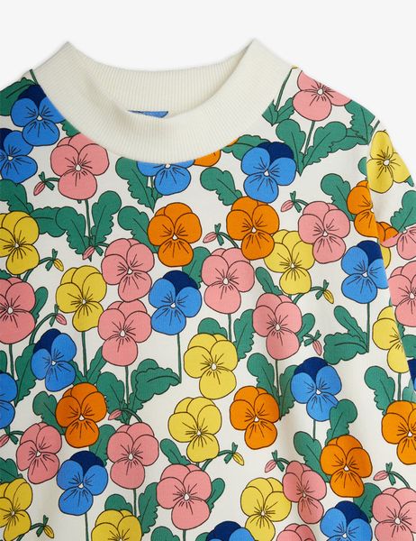 Close-up of the white dress featuring the colorful Violas floral print and a ribbed collar.