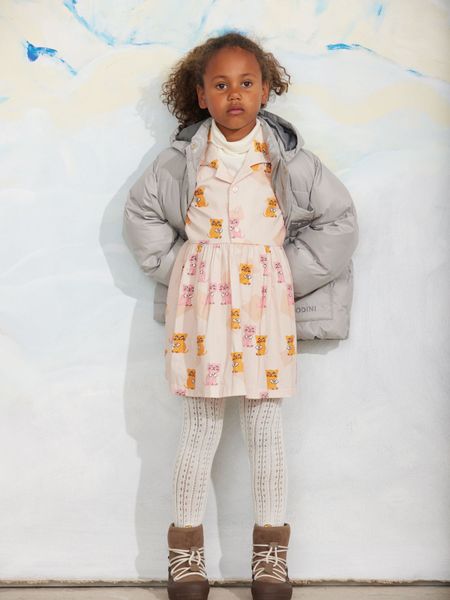 Pink dress featuring a Kittens print, pointed collar, and button front, styled with a grey puffer jacket.