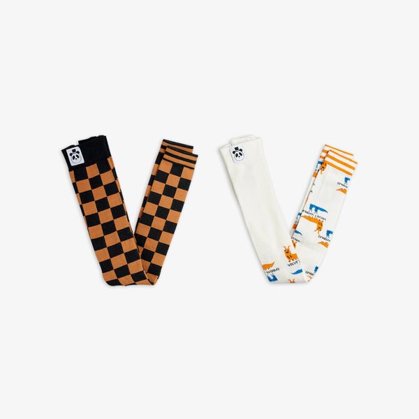 Organic cotton 2-pack leggings featuring a brown Chess check pattern and a white Velvet worm print.