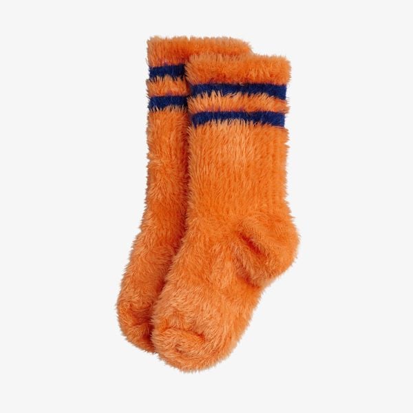Bright orange fluffy socks with dark blue stripes, crafted from a soft recycled polyester blend.
