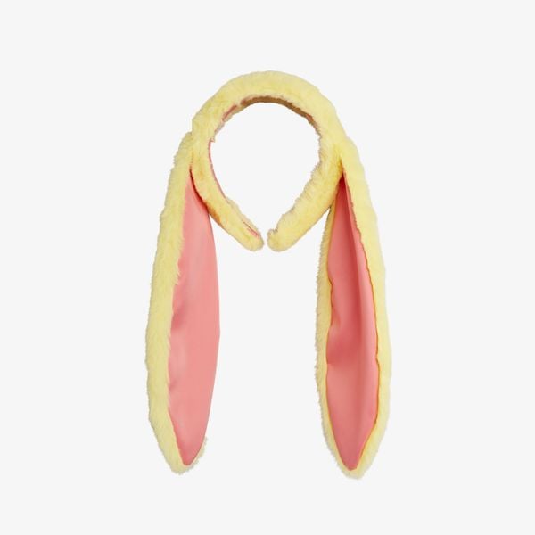 Yellow faux fur headband with long rabbit ears and pink contrast lining, made from recycled polyester.