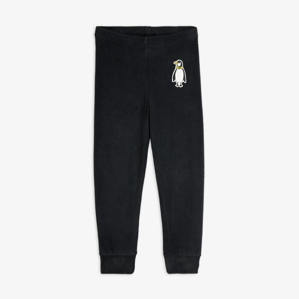 Black microfleece trousers with an elastic waist and a penguin patch on the upper leg.