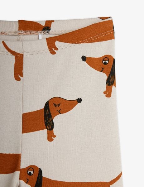 Close-up of grey leggings featuring a brown dachshund dog print and elasticated waistband.