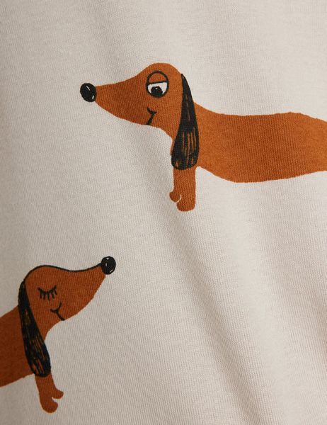 Close-up of grey dress fabric featuring a print of brown dachshund dogs.