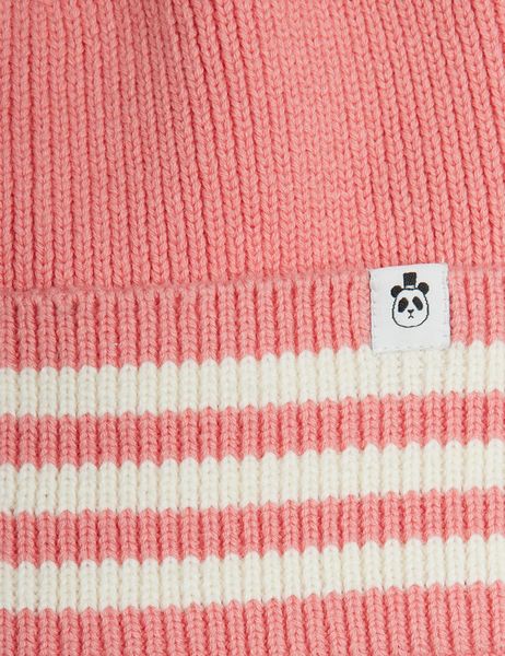 Close-up of a pink knitted beanie featuring a striped folded brim and a panda label.