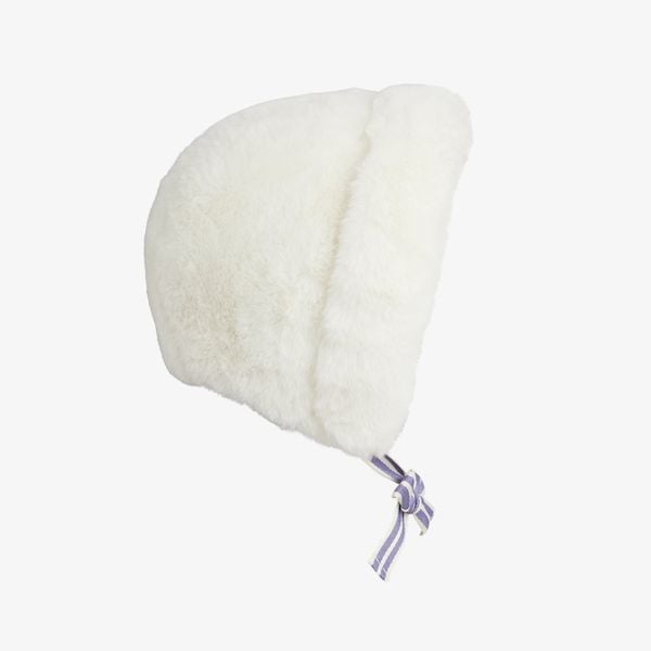 Off-white faux fur hat with a fold-up brim and striped tie strings under the chin.