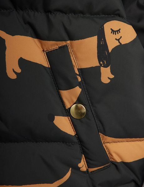 Gold snap button on a black puffer jacket pocket with brown Dog print.