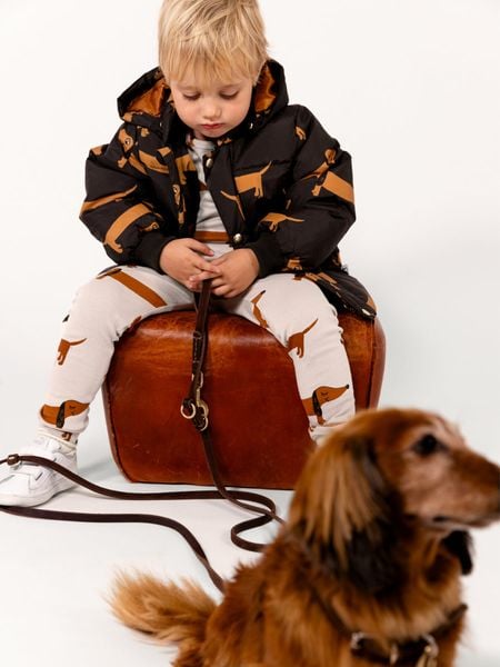 Black hooded puffer jacket featuring a Dog print and a removable hood.