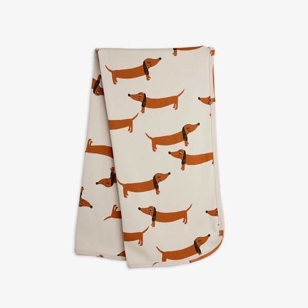 Grey swaddle blanket featuring a repeated brown dachshund dog print.