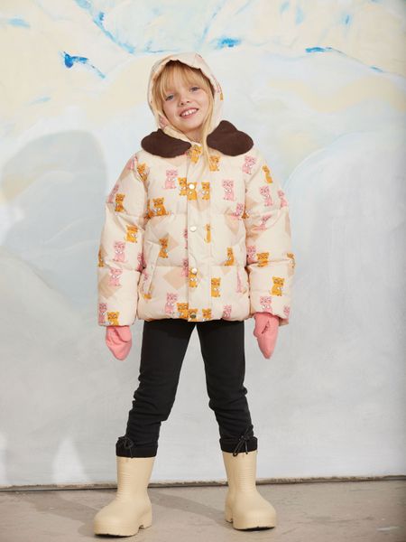 Padded puffer jacket featuring a Kittens print and brown faux fur collar, worn by a child.