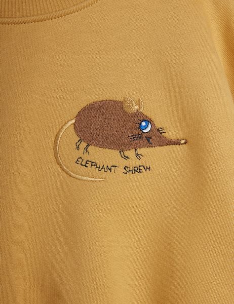 Brown Elephant Shrew embroidery with black text on a beige sweatshirt.
