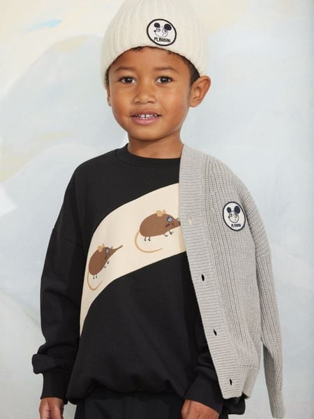 Black sweatshirt with Elephant shrew panel print, worn by a child wearing a beanie and grey cardigan.