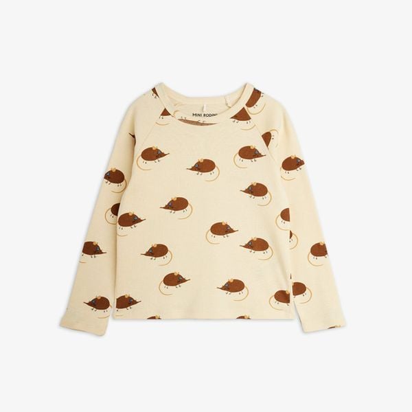 Beige long-sleeved t-shirt featuring an all-over brown Elephant shrew print and snap buttons at the shoulder.