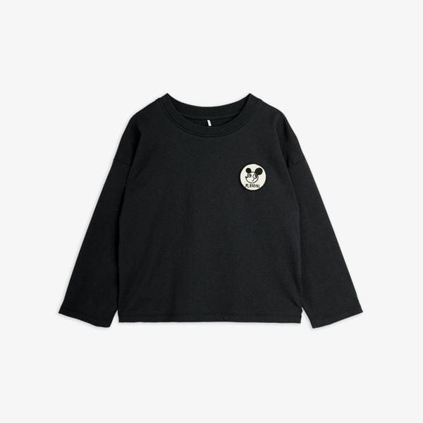 Black long-sleeved top featuring a white Ritzratz patch on the chest.