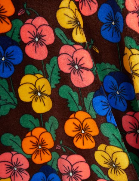 Close-up of brown velour fabric featuring a colorful all-over Viola flower print.