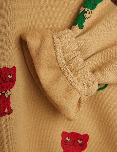 Beige sweatshirt ribbed cuff close-up featuring Kittens print and a soft brushed interior.