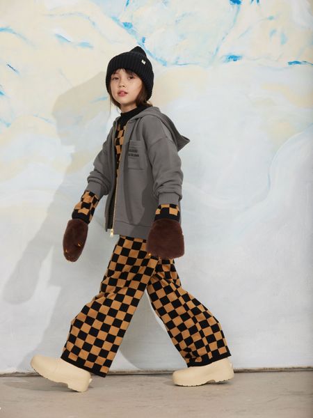 Grey zip-up hoodie with an embroidered chest pocket, worn by a child with a checkered outfit and brown mittens.