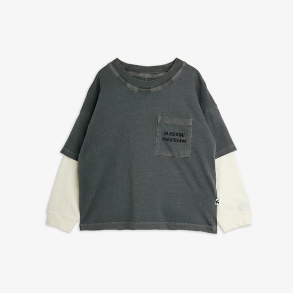 Grey organic cotton long-sleeved top with layered white sleeves and a Field Notes embroidered pocket.