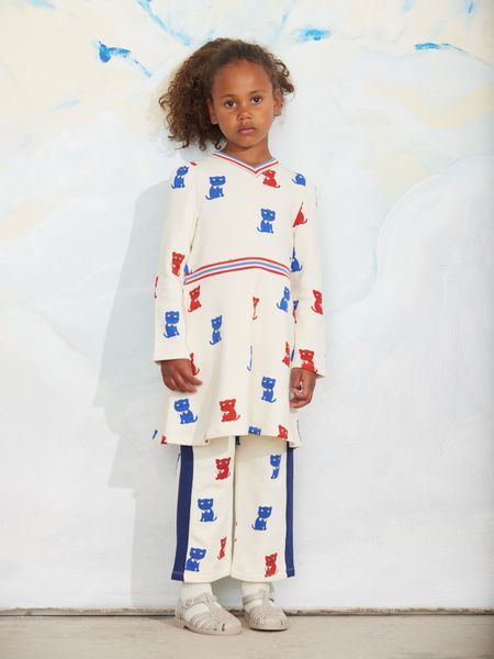 Off-white sweatpants with Kittens print and contrast side panels, worn by a child.