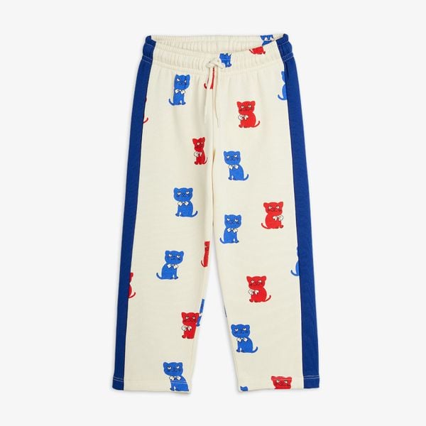 Off-white sweatpants featuring red and blue Kittens print, blue side panels and drawstring waist.