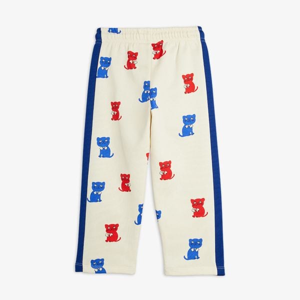 Off-white sweatpants featuring a red and blue Kittens print and blue contrast side panels.