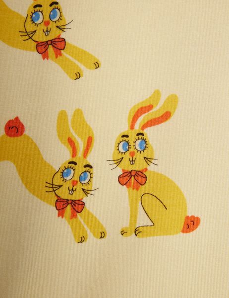 Close-up of the yellow Rabbits print featuring bunnies with red bowties and blue eyes.