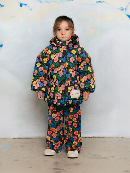 Child wearing matching Violas print hooded jacket and velour trousers.