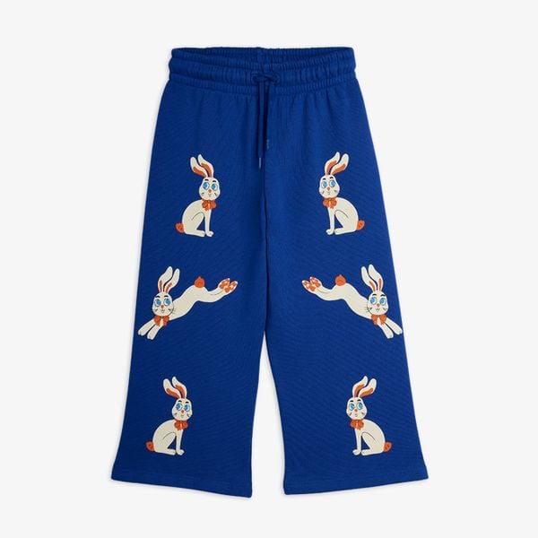 Blue wide-leg sweatpants featuring white rabbits with orange bows and an elastic drawstring waist.