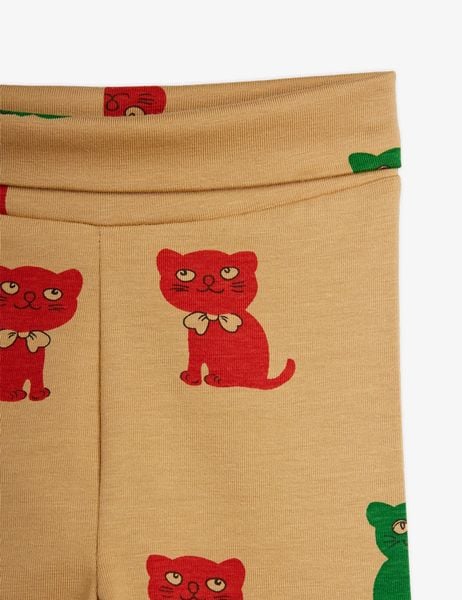 Close-up of beige leggings featuring an all-over red Kittens print and a foldable waistband.
