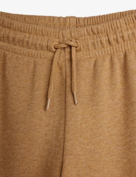 Elasticated waistband and knotted drawstring detail on brown melange sweatpants.