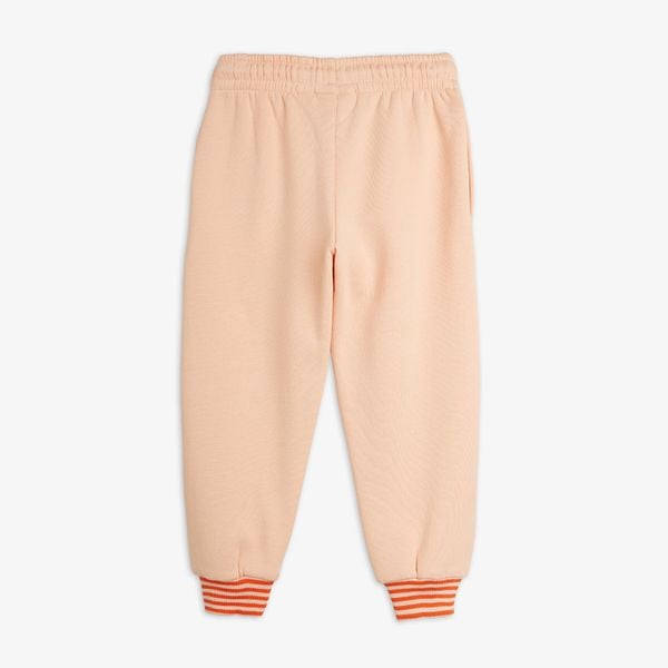 Pink sweatpants with an elasticated waist and orange striped ribbed cuffs, viewed from the back.