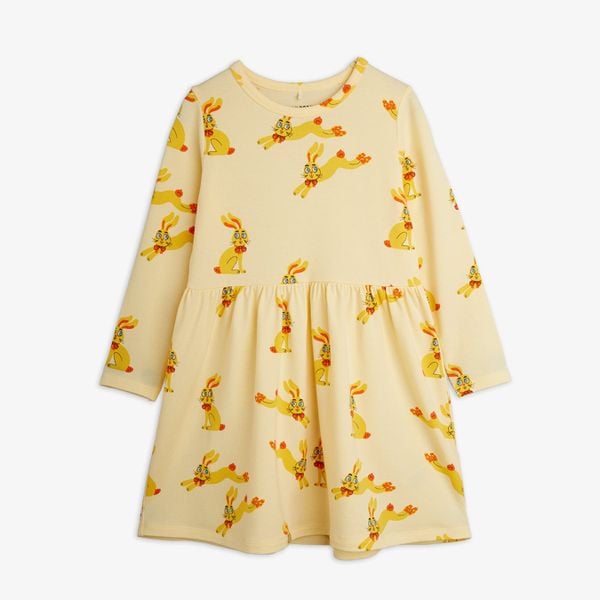 Yellow long-sleeved dress with an all-over Rabbits print, gathered waist, and shoulder buttons.