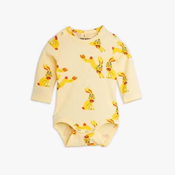 Yellow long-sleeve bodysuit featuring a Rabbits print and snap buttons at the shoulder and crotch.