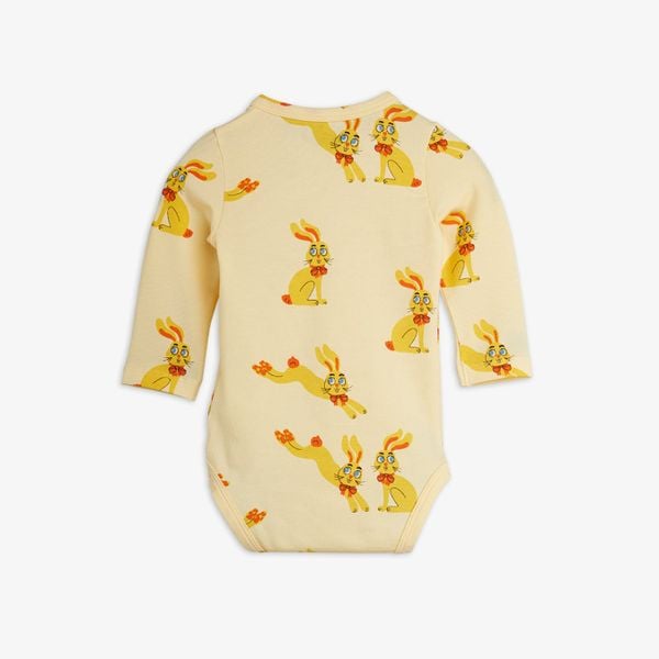 Yellow long-sleeved bodysuit featuring a repeating Rabbits print with yellow rabbits wearing red bows.