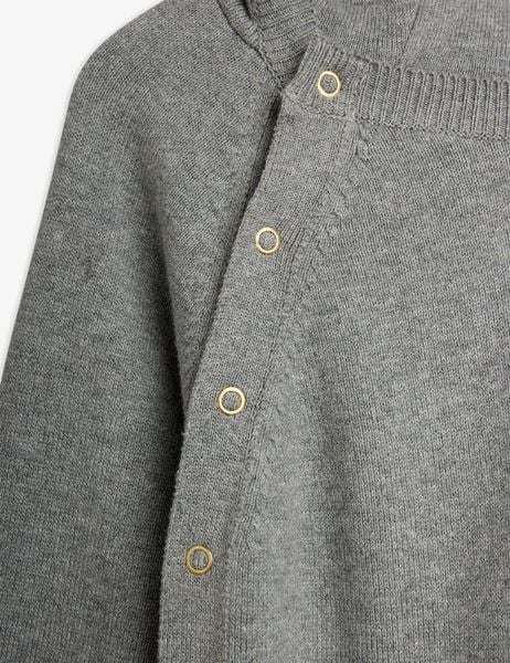 Gold-toned snap buttons and ribbed trim on a grey melange fine knit baby jumpsuit.