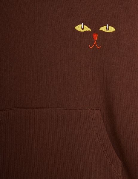Embroidered cat face and kangaroo pocket detail on a brown sweatdress.