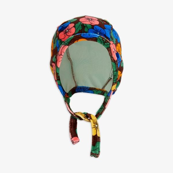Brown velour baby helmet featuring a colorful Violas print and adjustable tie-strings.