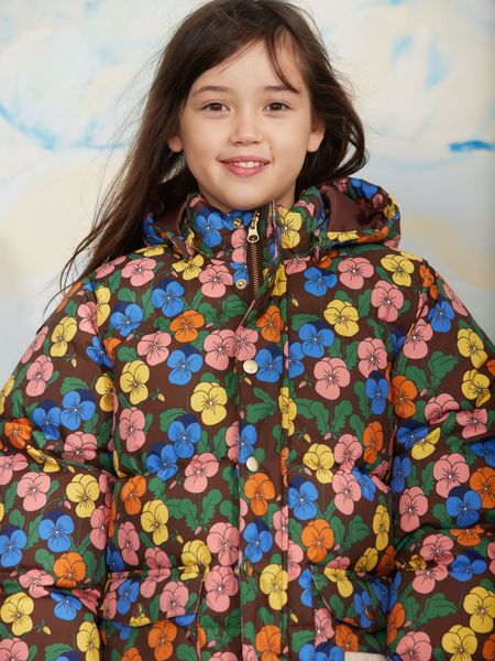 Brown heavy puffer jacket featuring a colorful Violas print and a hooded design, worn by a child.