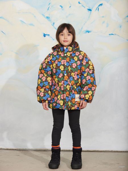 Brown heavy puffer jacket featuring a colorful viola print and front pockets, worn by a child.