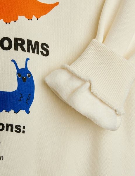 Off-white organic cotton sweatshirt with a ribbed cuff, soft fleece lining, and Velvet worms observations print.