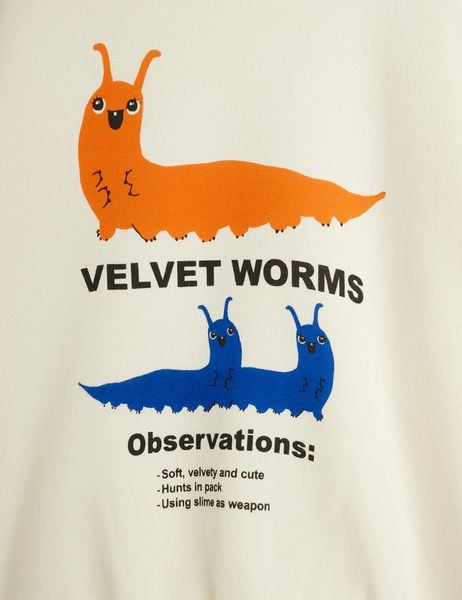Close-up of the Velvet worms observations print featuring orange and blue worms on off-white organic cotton.