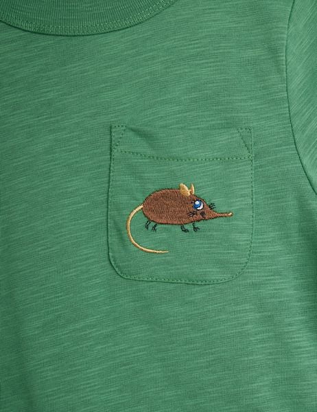 Green T-shirt chest pocket featuring a brown embroidered Elephant Shrew on textured organic cotton.