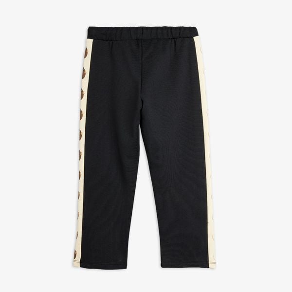 Black organic cotton sweatpants with cream Elephant shrew side panels, back view.
